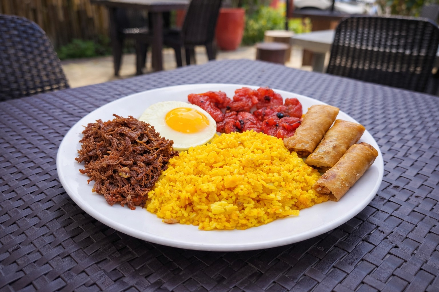 Combosilog plate with longganisa, fried egg, sinangag, and lumpia